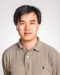 Michael Chan with black short hair and brownish grey polo shirt
